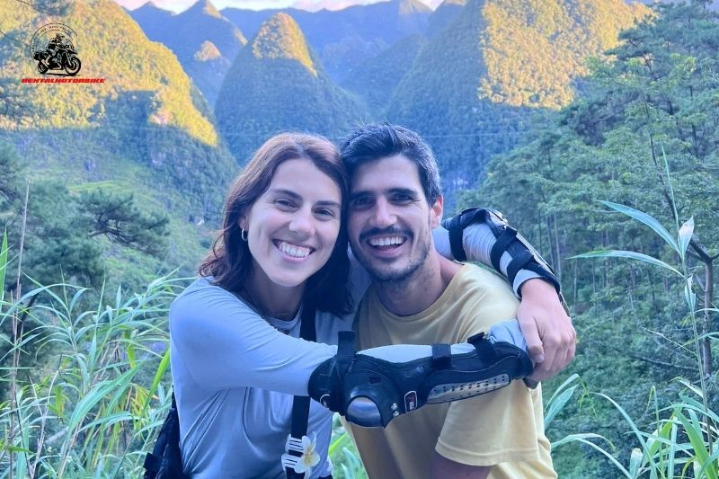 Happy couple smiling together in front of green mountains in Da Lat