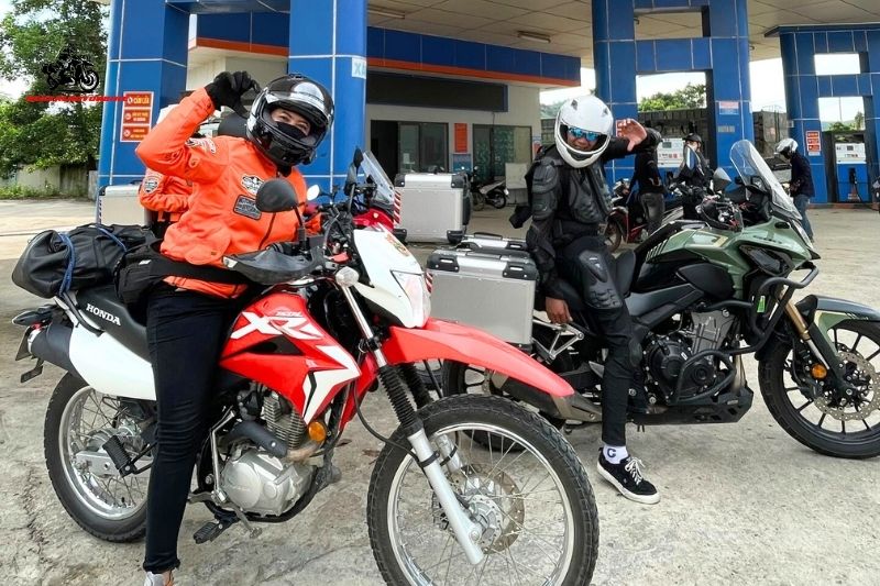 Bikers posing at a gas station before the journey