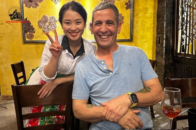 Smiling expat and local woman posing at restaurant