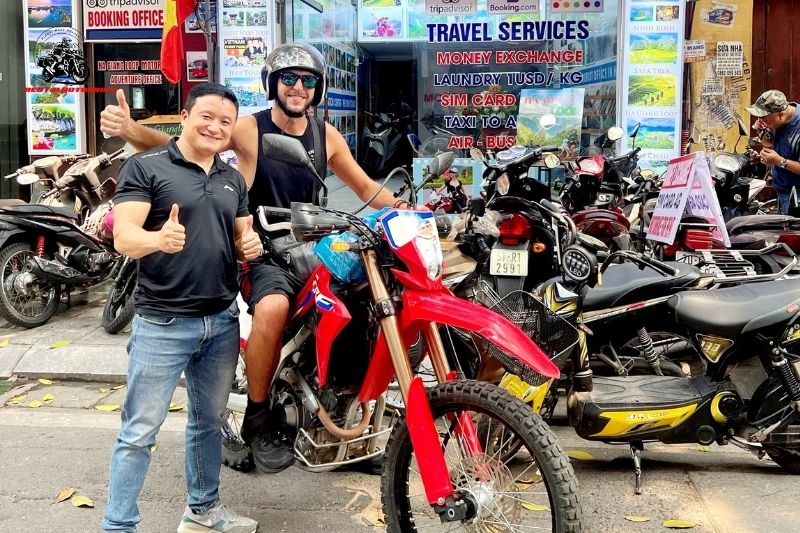Rental Motorbike staff handing over bike to happy expat