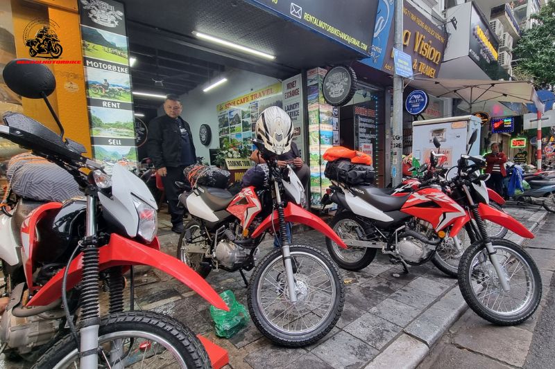 Dirt bikes parked in front of Rental Motorbike Hanoi shop